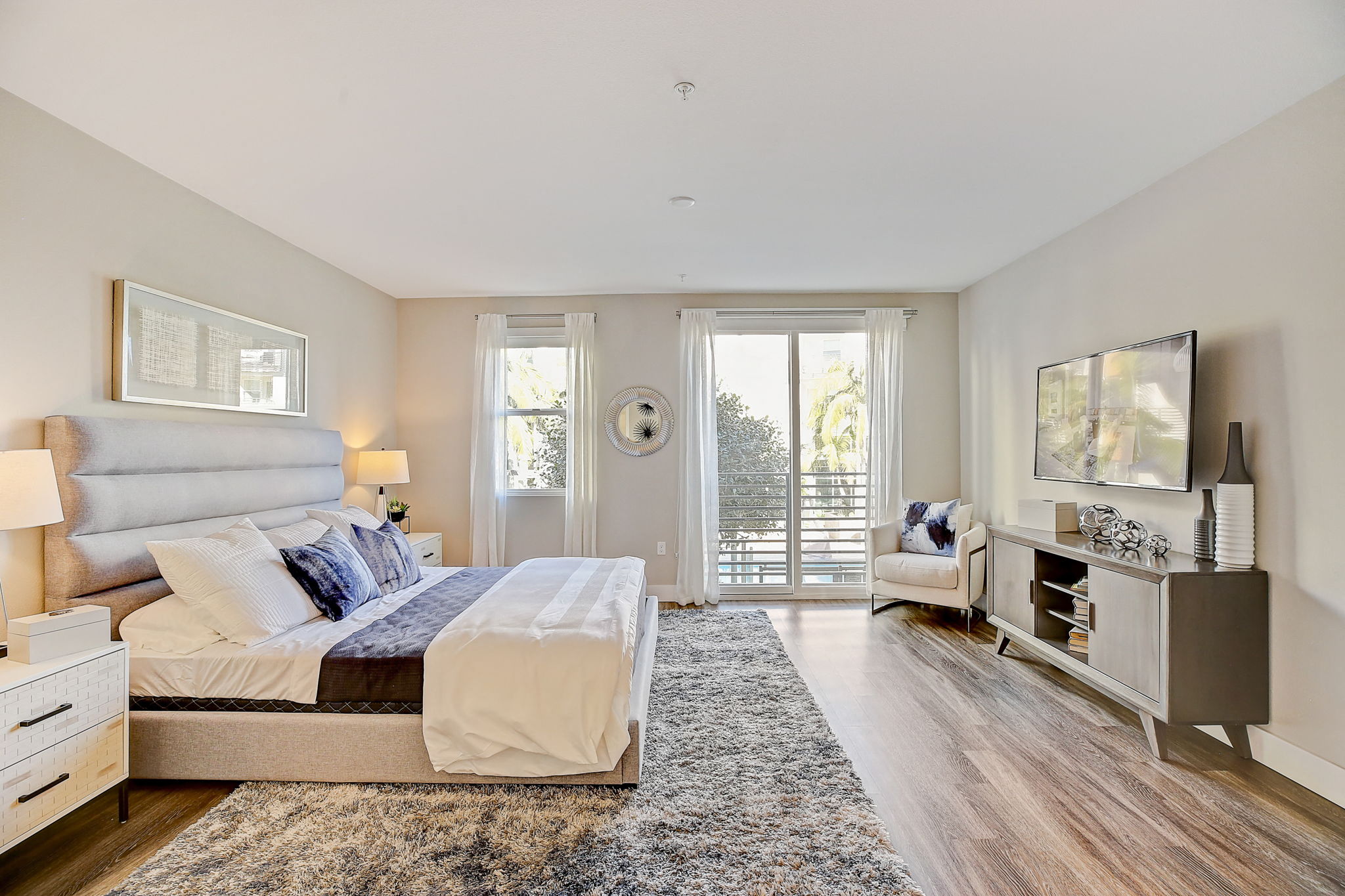 Cozy bedroom featuring a comfortable bed, flat-screen TV, and door leading to a private balcony,Cozy bedroom featuring a comfortable bed, flat-screen TV, and door leading to a private balcony